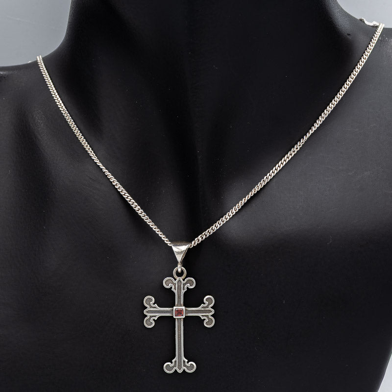 Sterling silver cross with a Garnet