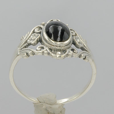 Sterling silver ring with onyx surrounded by patterns