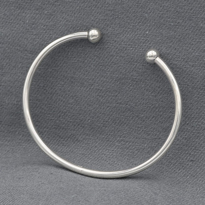 Sterling silver round bangle with a 6mm silver ball at the ends