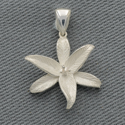 A sterling silver pendant in the shape of a flower with polished petal edges on a textured background.