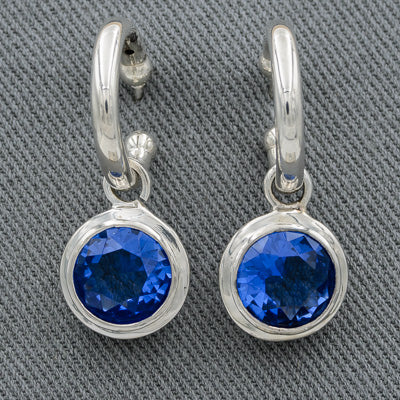 Sterling silver pretty woman with blue cubic zirconia.