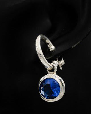 Sterling silver pretty woman with blue cubic zirconia.