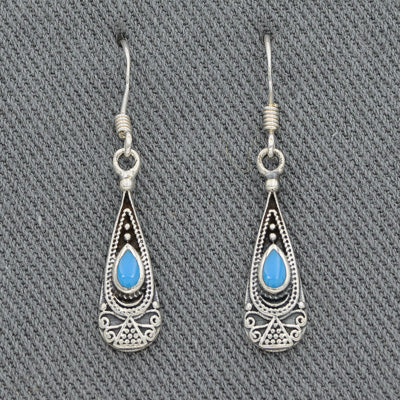 A sterling silver drop earring with a stone