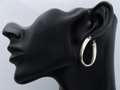 Sterling silver flat hoop with a twist