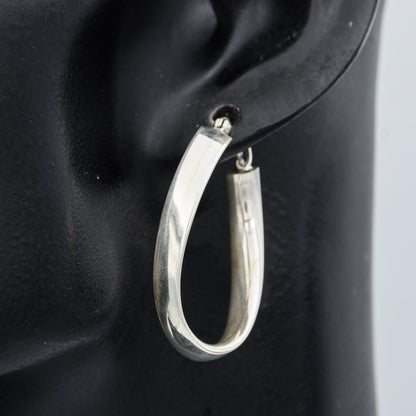 Sterling silver flat hoop with a twist