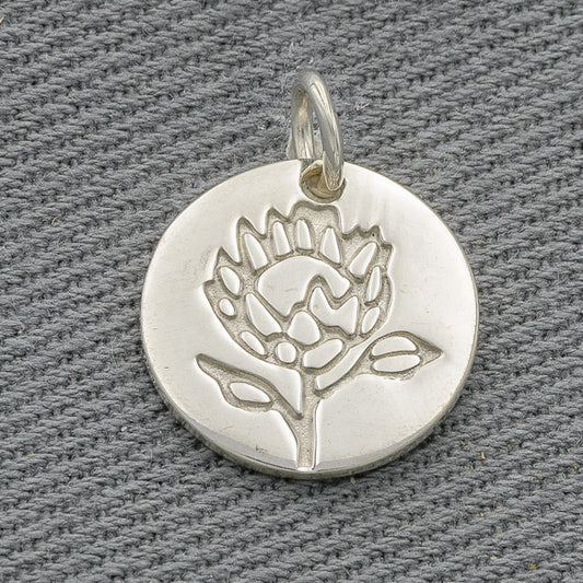 Sterling silver disc with a protea engraving