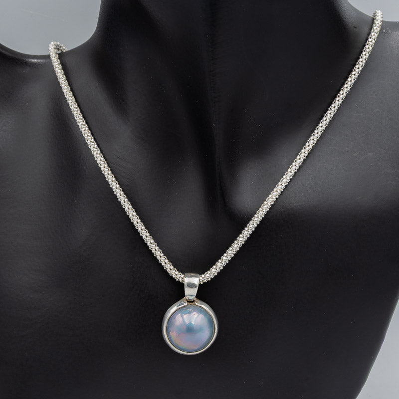 Blue mabe' set in silver pendant