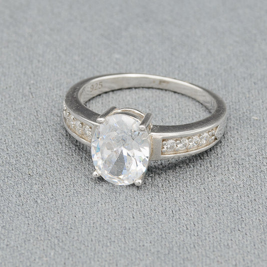 Oval cubic set in sterling silver ring with cubics on the side