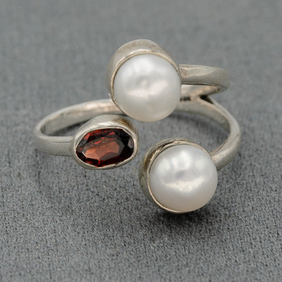 Sterling silver ring with  pearls and a garnet.