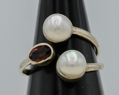 Sterling silver ring with  pearls and a garnet.