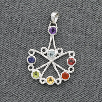 A sterling silver pendant with a fan-like design, featuring an array of semi-precious stones in different colors at the end of each spike.