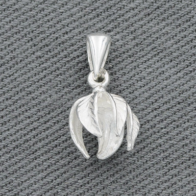 A sterling silver petal-shaped pendant with a brushed finish, displayed against a textured background.