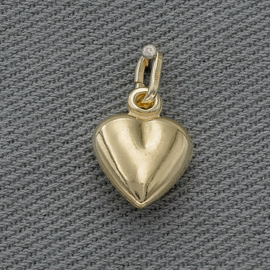 Gold heart-shaped pendant on a gray textured background